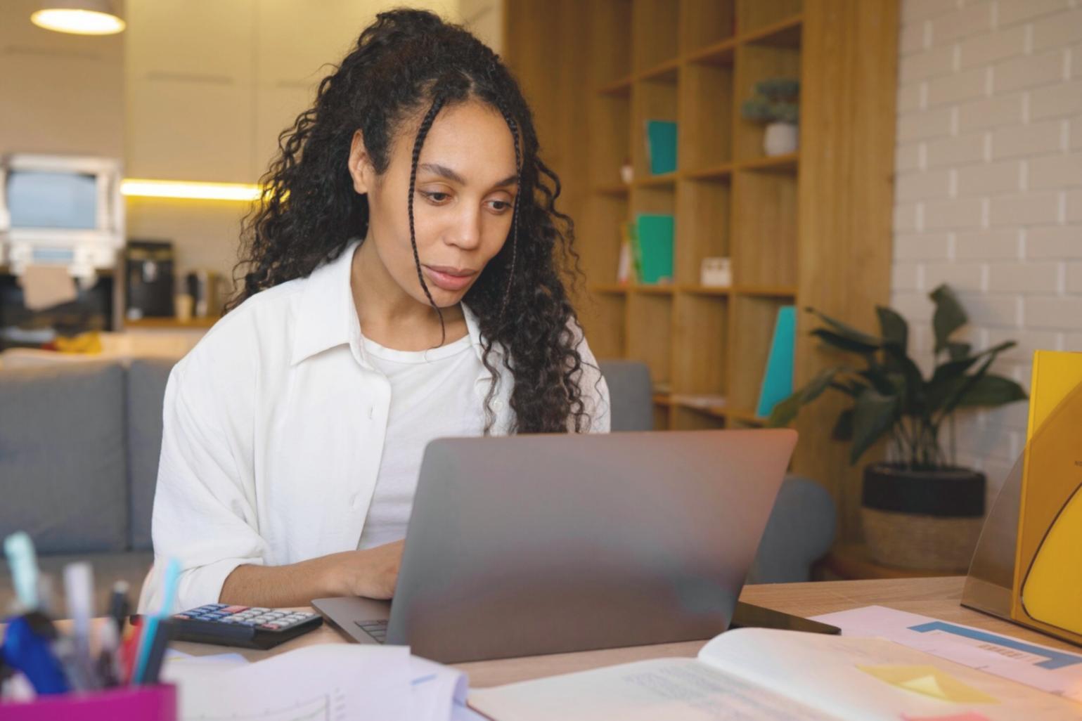 Professional financial analysis workspace with documents and digital tools